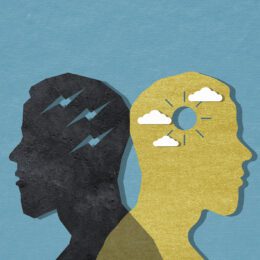 Two paper cutouts of a man, one happy one sad.